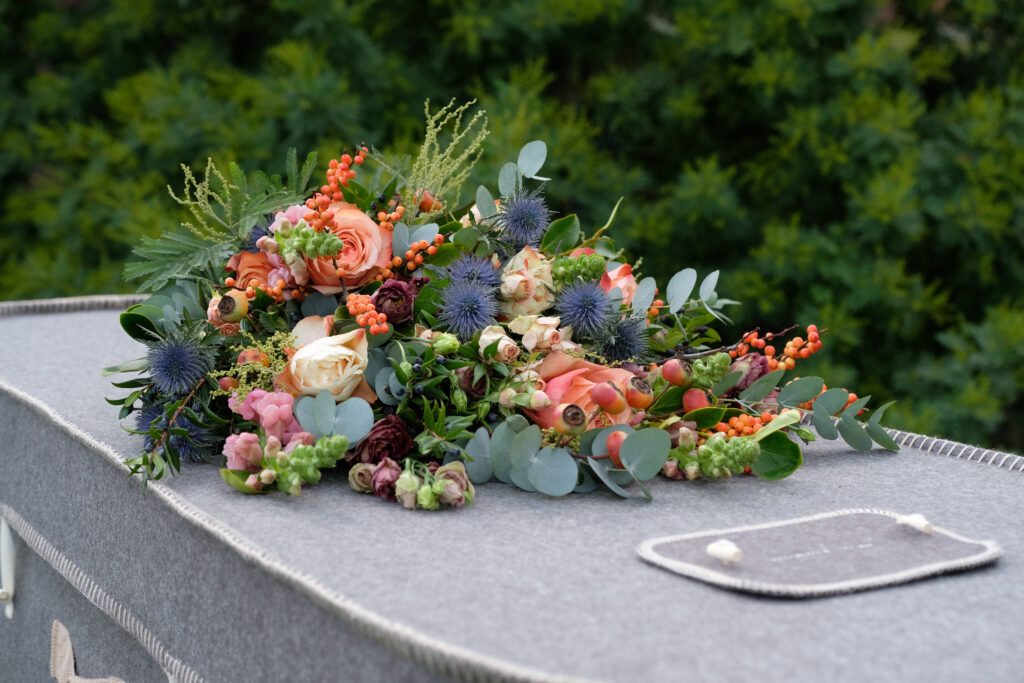 alternative to cremation felt coffin with flowers on top